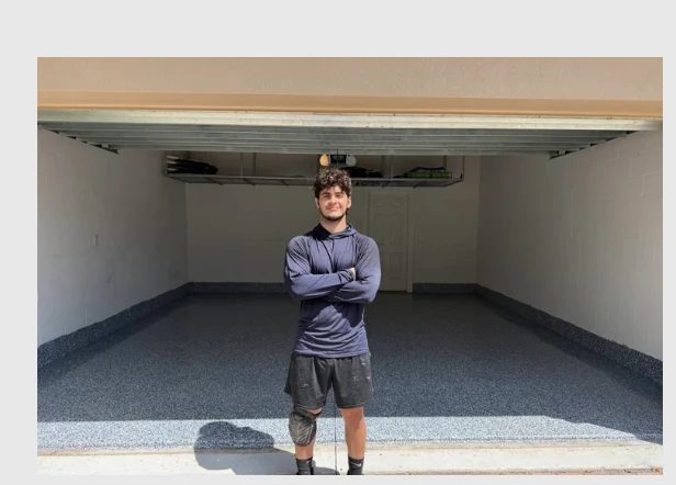 Fine Flakes Epoxy contractor in front of a freshly coated gray decorative flake garage floor